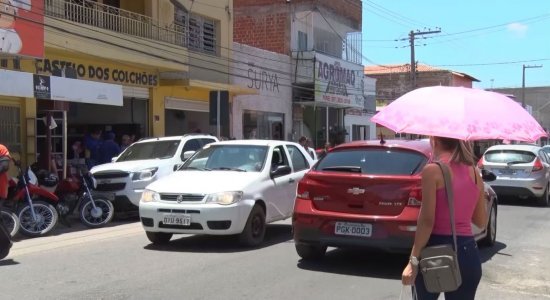 Moradores utilizam sombrinhas para se proteger do sol