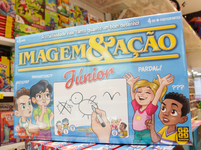 A imagem mostra a caixa do jogo "Imagem ENTITY_amp_ENTITYAção Júnior" da Grow, ilustrada com crianças animadas.