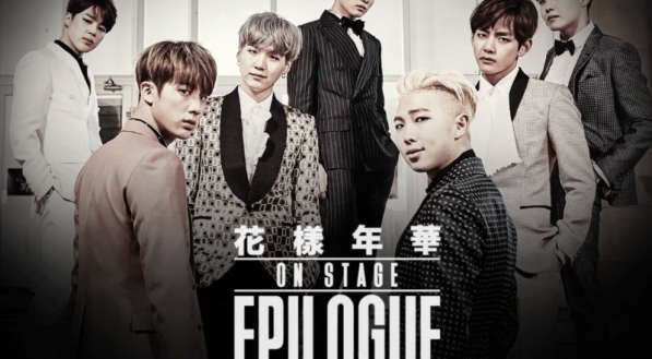 Divulga&ccedil;&atilde;o do filme do grupo de K-pop BTS. S&atilde;o 7 homens coreanos vestidos formalmente com blazer, camisa e cal&ccedil;a social. Quatro deles tem cabelo preto, dois s&atilde;o loiros e um tem o cabelo cor castanho. Na imagem ainda tem um texto com palavras em coreano e ingl&ecirc;s, al&eacute;m dos nomes dos cantores no rodap&eacute;.