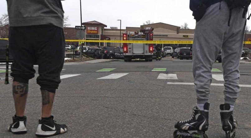 Espectadores ficam do lado de fora do supermercado King Soopers em Boulder, Colorado, em 22 de mar&ccedil;o de 2021, ap&oacute;s relatos da a&ccedil;&atilde;o de um atirador