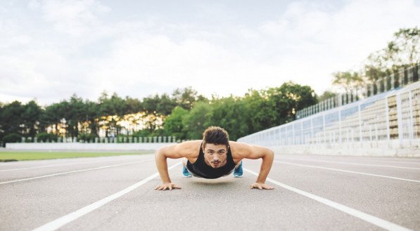 Imagem ilustrativa de atleta fazendo flexão no chão