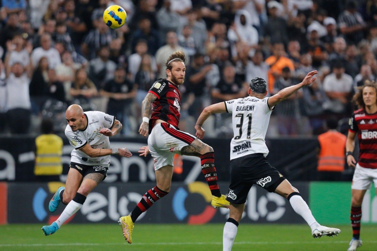 Ayrton Lucas of Flamengo heads the ball against Matias Rojas of