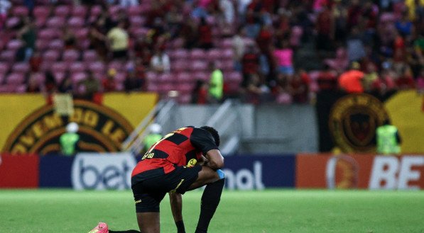 Imagem de jogador do Sport ajoelhado no gramado da Arena de Pernambuco