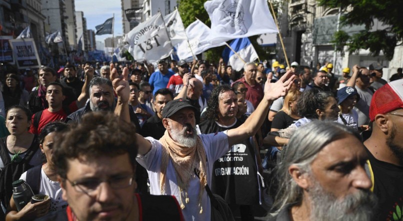 Integrantes de movimentos sociais gritam palavras de ordem durante protesto contra os cortes do governo do presidente Javier Milei nos setores mais vulneráveis