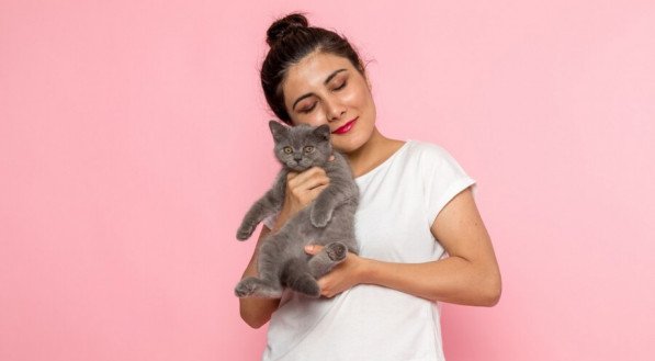Mulher com gato no colo fofo sorrindo