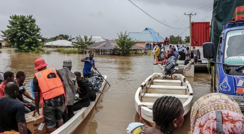 Moradores são resgatados em barcos numa área fortemente afetada por inundações após chuvas torrenciais no distrito de Rufiji