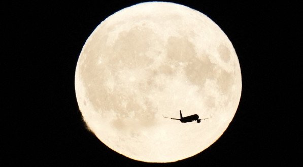 Avião passando pela Superlua azul em Copenhagen, na Dinamarca