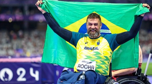Imagem do atleta brasileiro André Rocha com a bandeira do país