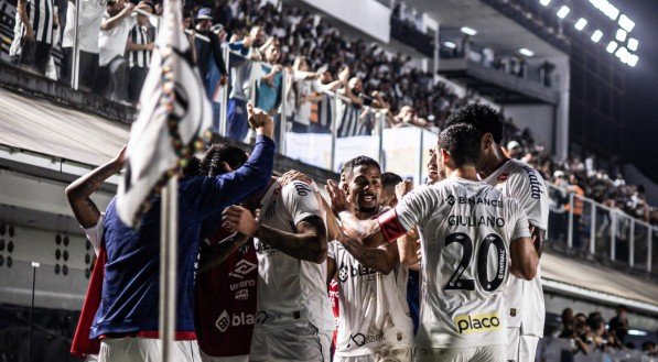 Jogadores do Santos abraçados próximo à bandeira de escanteio