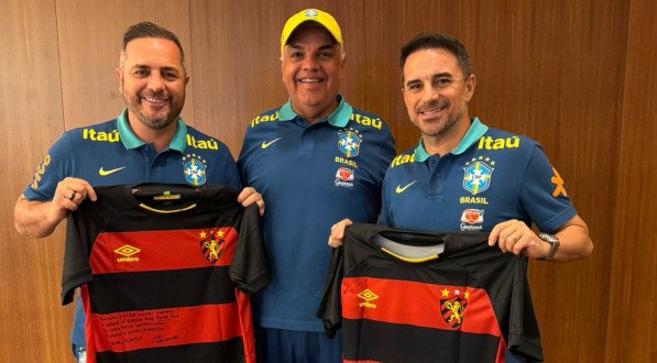 Cícero Souza (E), Yuri Romão (C) e Rodrigo Caetano (D) pela delegação da Seleção Brasileira posando com a camisa do Sport