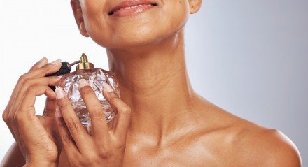 Imagem ilustrativa de uma mulher passando perfume!