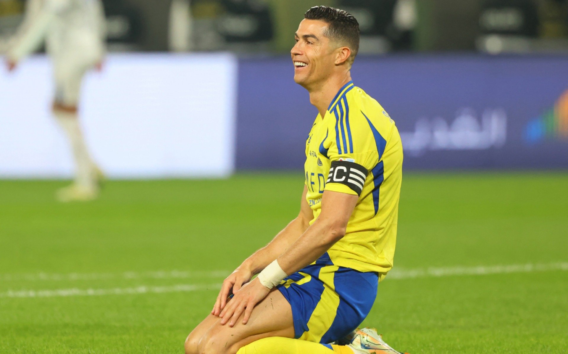 Cristiano Ronaldo sorrindo ironicamente em jogo do Al-Nassr Fayez Nureldine/AFP