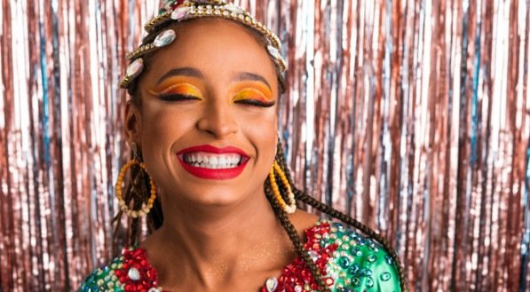 Carnaval in Brazil, cheerful black woman in carnaval costume at brazilian party with fashion makeup