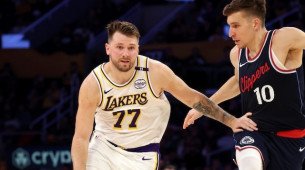 Mar 2, 2025; Los Angeles, California, USA; Los Angeles Lakers guard Luka Doncic (77) dribbles against LA Clippers guard Bogdan Bogdanovic (10) during the second quarter at Crypto.com Arena. Mandatory Credit: Jason Parkhurst-Imagn Images