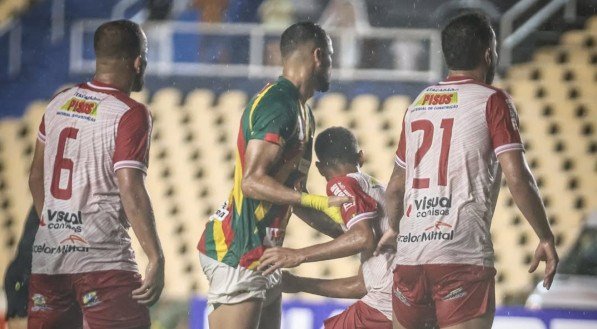 Jogadores em disputa por espaço dentro área antes de cobrança de escanteio
