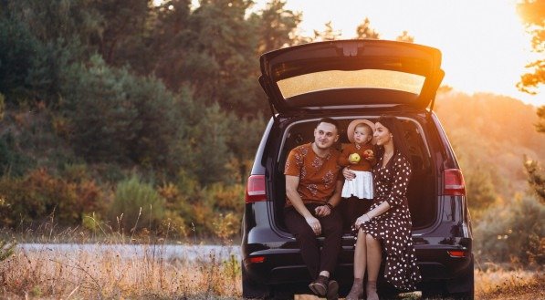 Family with little daughter travelling by car