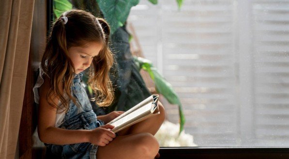 Imagem de criança lendo um livro