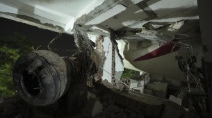 Inside view of a canteen building where the tail of the airplane stuck at the site of an airplane that crashed in India's northwestern city of Ahmedabad in Gujarat state, India, Thursday, June 12, 2025. (AP Photo/Ajit Solanki)