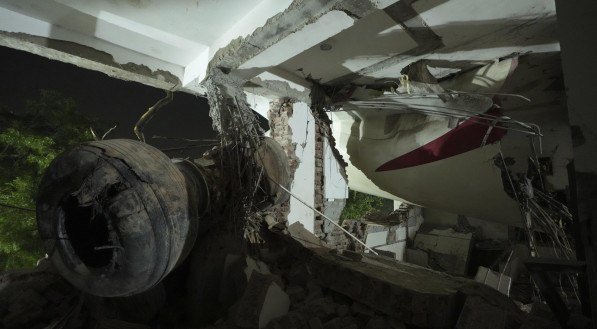 Inside view of a canteen building where the tail of the airplane stuck at the site of an airplane that crashed in India's northwestern city of Ahmedabad in Gujarat state, India, Thursday, June 12, 2025. (AP Photo/Ajit Solanki)