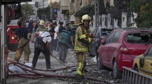 Bombeiros trabalham no local de uma explosão em um complexo residencial após Israel atacar a capital do Irã, Teerã