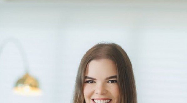 Juliana Lins, em ensaio fotográfico afetivo, segurando o livro do pai, Tarcísio Pereira