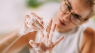 Imagem de uma mulher lavando as mãos para representar o conceito de transtorno obsessivo compulsivo. 