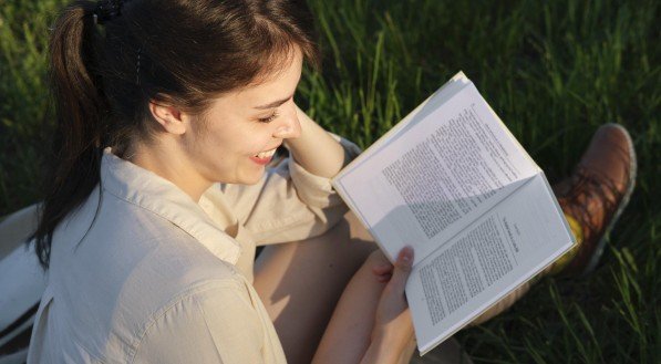 Imagem ilustrativa de mulher lendo livro