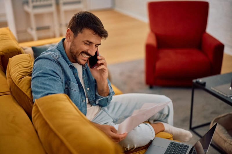 Imagem de um homem feliz falando ao celular