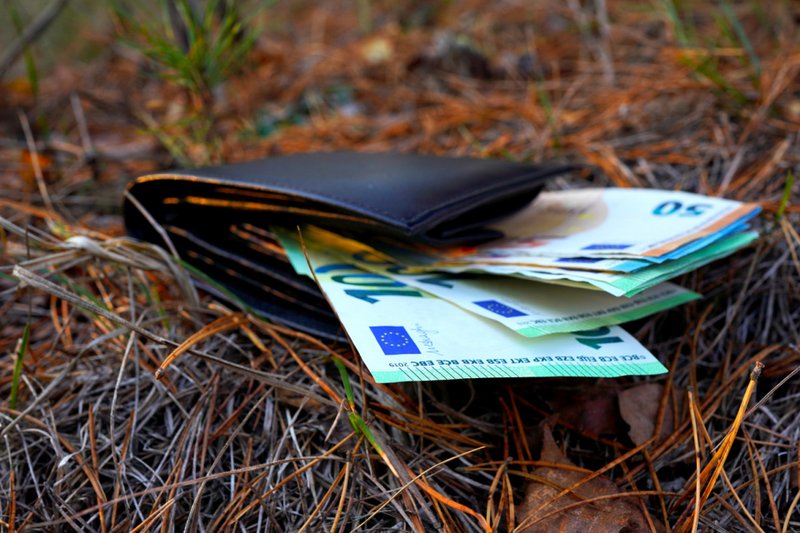 Imagem de uma carteira caída com dinheiro perdido