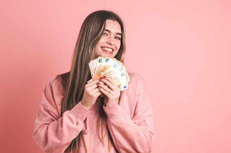 Imagem ilustrativa de uma mulher com dinheiro! 