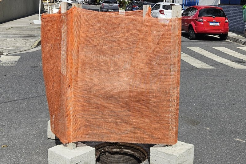 Bueiro sem tampa em via movimentada