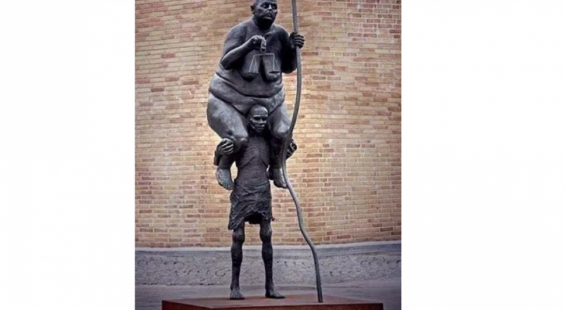 Escultura de autoria do dinamarqu&ecirc;s Jens Galschiot representa a Justi&ccedil;a como uma
senhora pesada, com uma pequena balan&ccedil;a na m&atilde;o, sendo carregada nos ombros por um fam&eacute;lico cidad&atilde;o