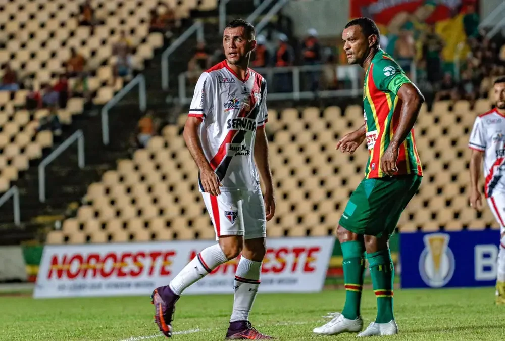 Imagem ilustra jogador do Sampaio Corrêa marcando atleta do Ferroviário