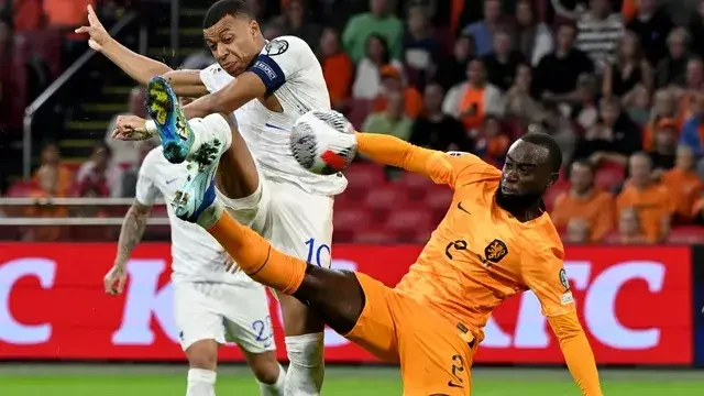 Imagem ilustra Mbappé chutando bola em partida contra Holanda